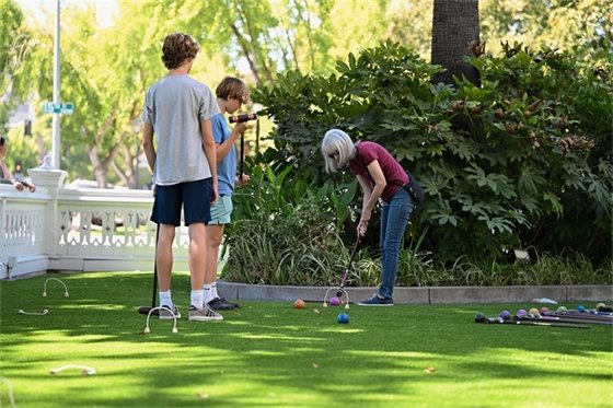 Family playing croquet at the McHenry Mansion.