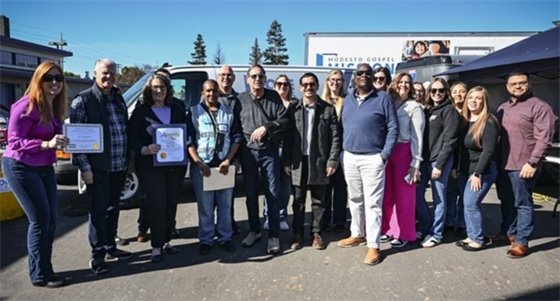 City of Modesto staff, the Mayor, Council Members, and members of the HopeWorks staff stand together at the Ribbon Cutting Ceremony for HopeWorks. 