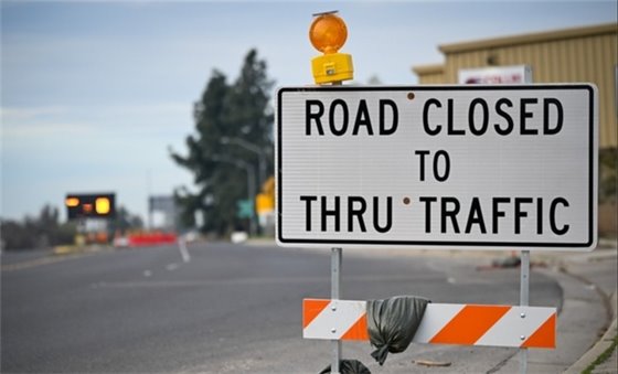 Road Closed to thru traffic sign at the construction site for the City of Modesto River Trunk Rehabilitation Project