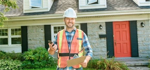 Photo of person standing in front of house.