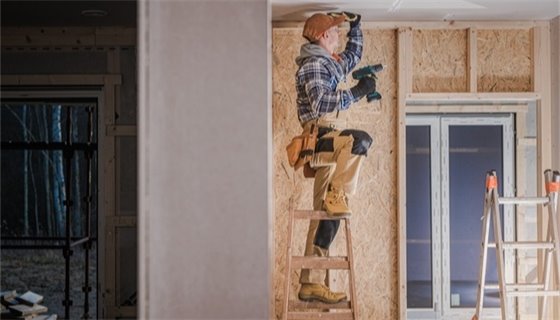 Person working on house. 