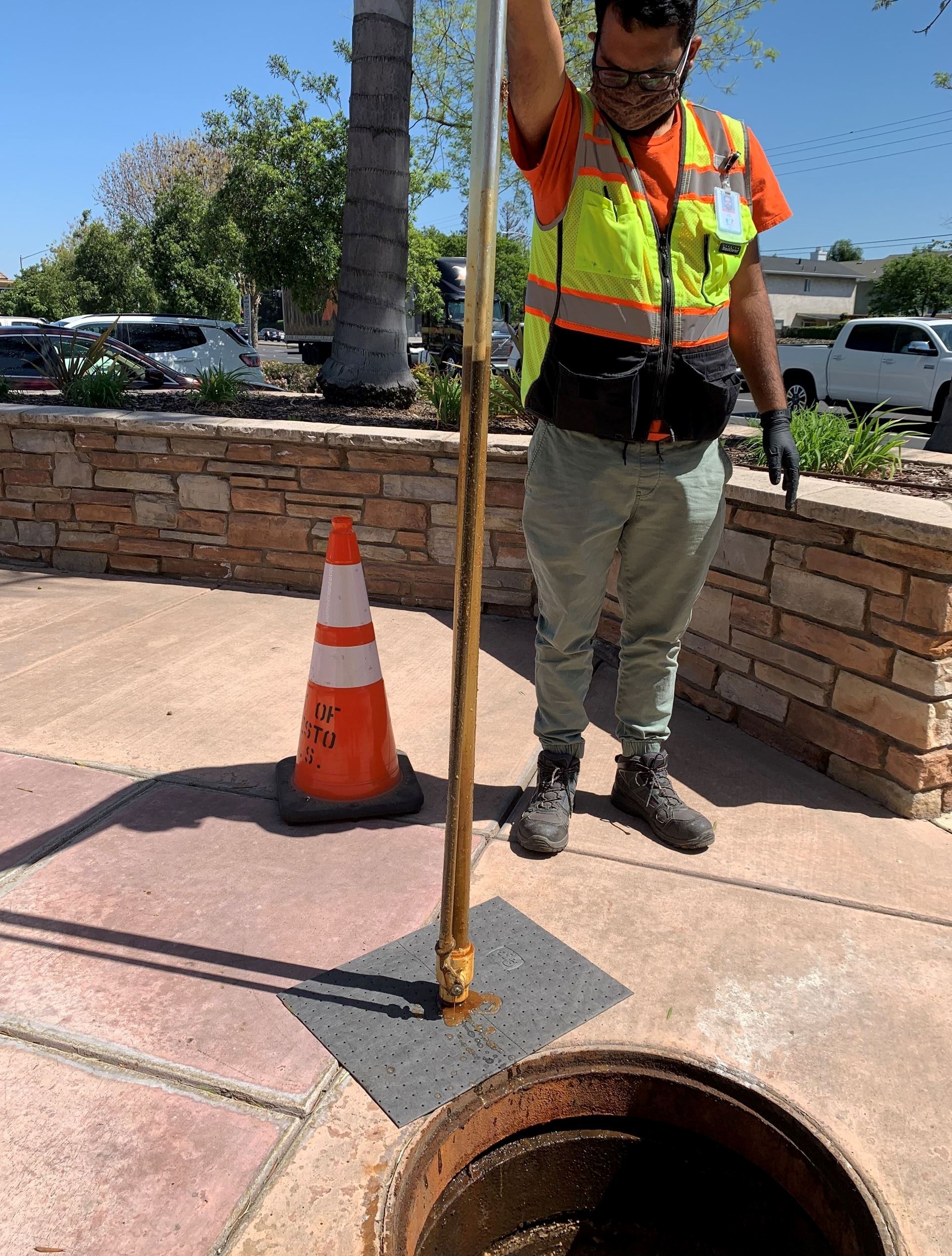 Environmental Compliance employee inspecting the FOG levels.