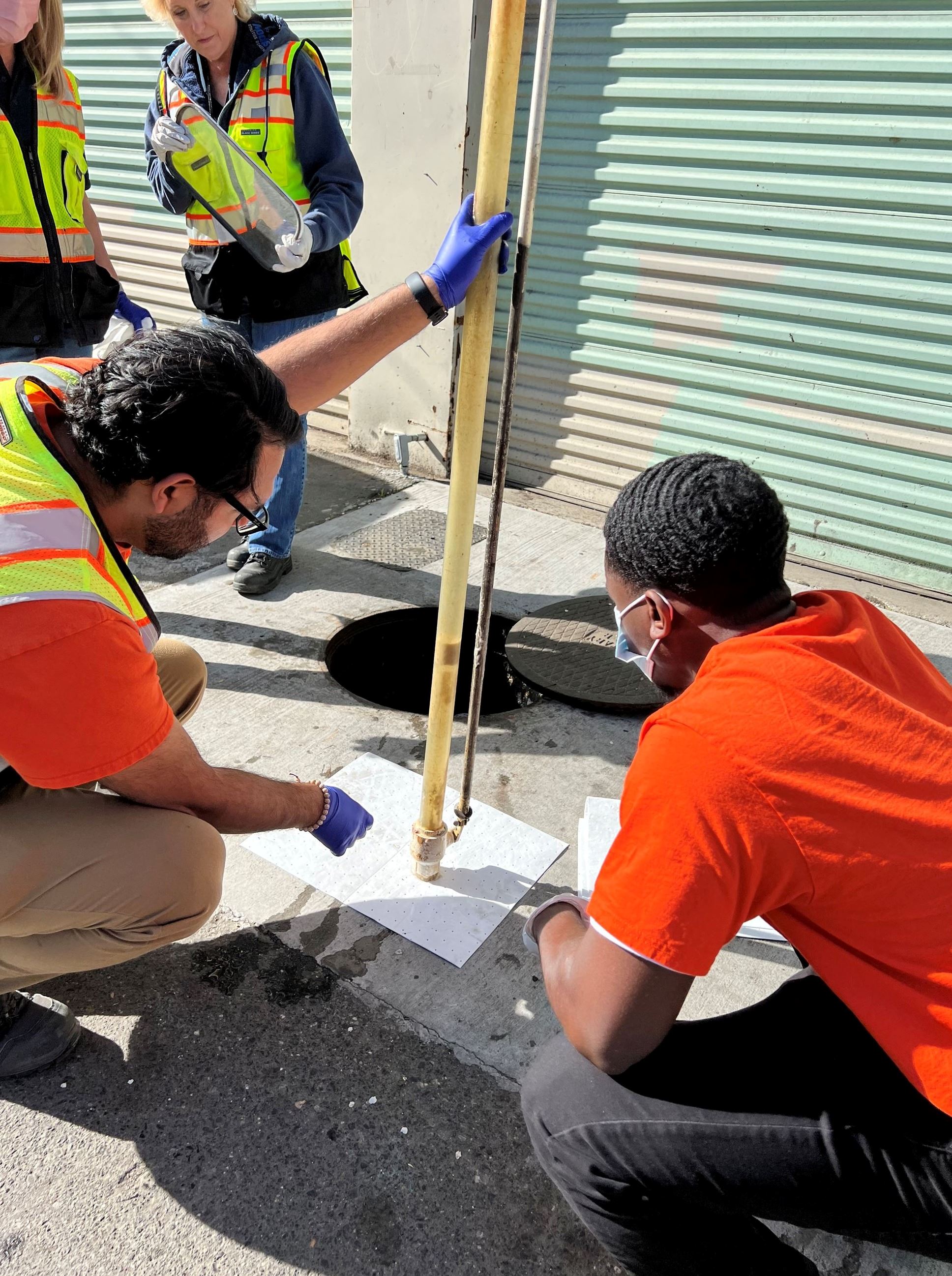 Environmental Compliance Employees inspecting the FOG levels.